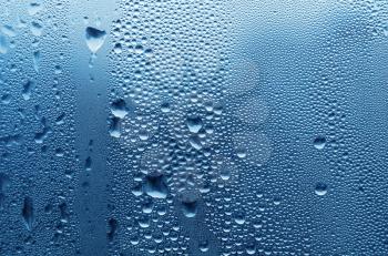 large and fine water drops on glass