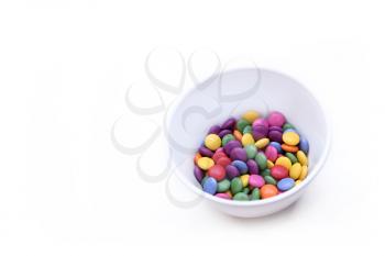 White background with colorful bright candy in bowl