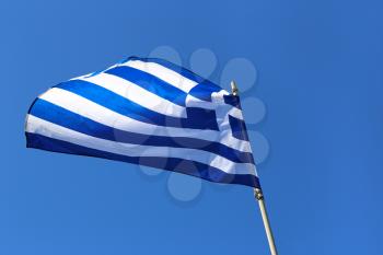 Greek Flag against bright blue sky 