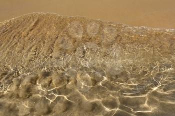Transparent sea wave on the sand           