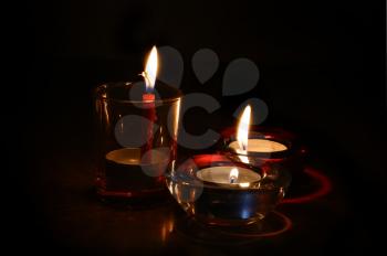 Three bright burning candles in the dark