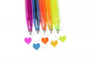 Bright colorful pens and abstract hearts on white background