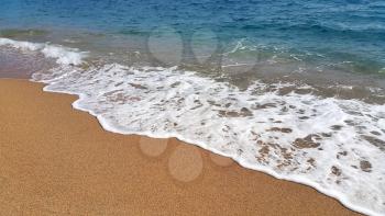 Sea waves on the sand beach