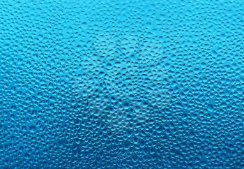 Water drops on glass naural blue background