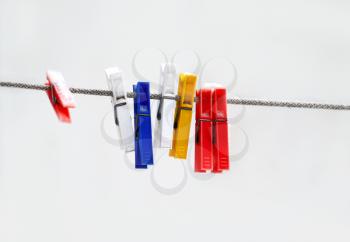 Colorful plastic clothespins hanging on a rope