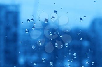 Natural blue texture of water drops on turbid window glass