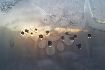 Texture of window glass with water drops, ice pattern and sunlight