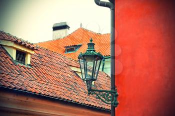 Traditional street lamp and the tiled roofs of Prague, Czech Republic 