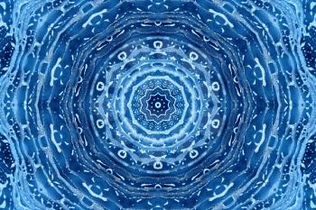 Blue background with concentric abstract pattern of soap foam on glass