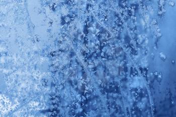 Beautiful natural blue ice pattern on winter glass