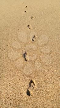 Human footprints in the sand, natural background