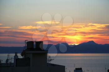 Beautiful sunset on the sea and top of roofs with antennas, Balearic Islands, Mallorca (Majorca), Spain
