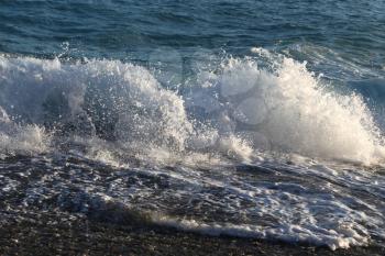 Big waves and white sea foam on the coast