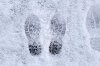 Marks of shoes in the snow background