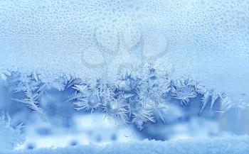 Beautiful ice pattern and frozen water drops on window glass