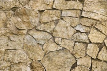 Texture of old stone wall, built of large stones, close-up