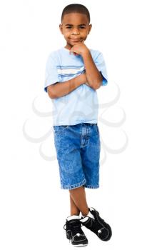 Royalty Free Photo of a Young Boy with his Hand on his Chin Posing for the Camera
