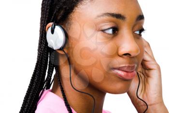 Royalty Free Photo of an African American Girl Listening to Music with Headphones