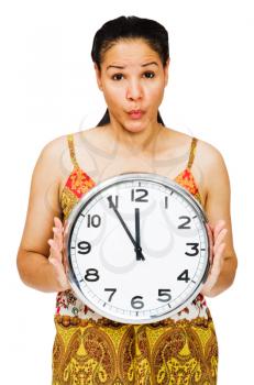 Royalty Free Photo of a Young Woman Puckering her Lips and Holding a Clock