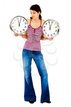Royalty Free Photo of a Young Girl Holding Two clocks