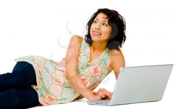Royalty Free Photo of a Young Woman Laying on the Ground Working on a Laptop