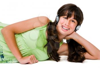 Royalty Free Photo of a Young Girl Laying Down Wearing Headphones
