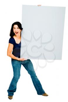 Royalty Free Photo of a Woman Holding a Blank Placard with an Enthusiastic Look on her Face