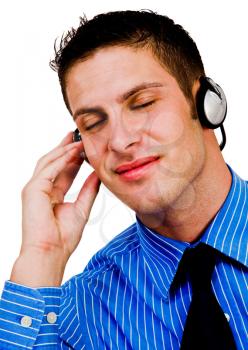 Royalty Free Photo of a Young Man Closing his Eyes Listening to Music on Headphones