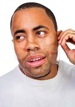 Royalty Free Photo of a Man Listening to Music on Earbuds
