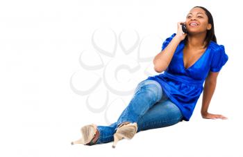 Royalty Free Photo of a Woman Sitting on the Floor Talking on a Cellular Phone