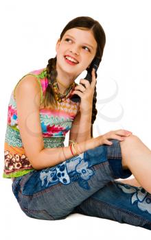 Royalty Free Photo of a Girl Sitting Down Talking on a Cell Phone