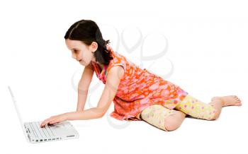 Royalty Free Photo of a Girl Sitting on the Floor Using a Laptop