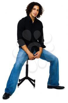 Royalty Free Photo of a Male Model Sitting on a Stool 
