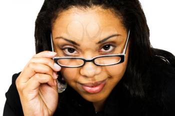 Royalty Free Photo of a Woman Adjusting her Glasses and Smiling