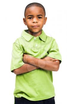 Royalty Free Photo of a Young Boy Standing and Posing with a Solemn Face