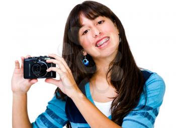 Royalty Free Photo of a Teenage Girl with Braces Holding a Camera