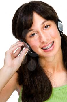 Royalty Free Photo of a Teenage Girl With Braces Listening to Music on Headphones
