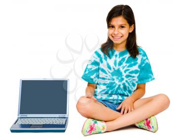 Royalty Free Photo of a Young Girl Sitting on the Floor Next to a Laptop