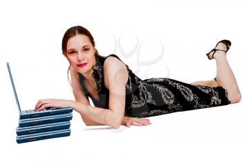 Royalty Free Photo of a Woman Laying on the Floor Using a Laptop on Top of a Stack of More Laptops