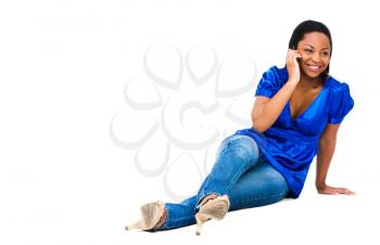 Royalty Free Photo of a Woman Sitting on the Floor Talking on a Mobile Phone