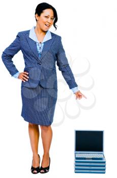 Royalty Free Photo of a Businesswoman Pointing at a Stack of Laptops
