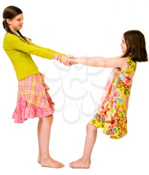 Royalty Free Photo of Two Young Girls Holding Hands and Spinning