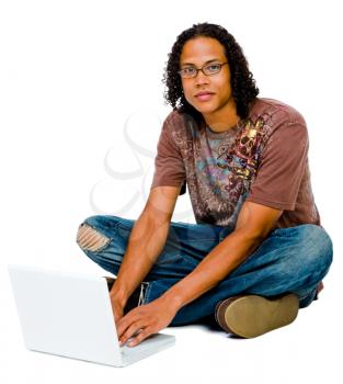 Royalty Free Photo of a Man Sitting on the Floor Using a Laptop