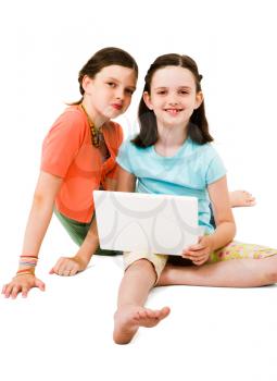 Royalty Free Photo of Young Girls Using a Laptop