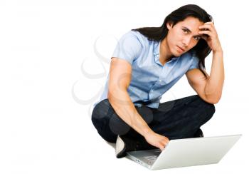 Royalty Free Photo of a Man Sitting on the Floor Using his Laptop