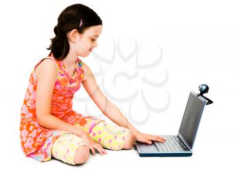 Royalty Free Photo of a Young Girl Sitting on the Floor Using a Laptop