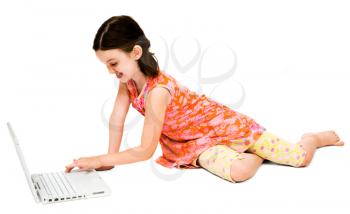 Royalty Free Photo of a Young Girl on the Floor Using a Laptop