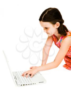 Royalty Free Photo of a Young Girl Using a Laptop on the Floor