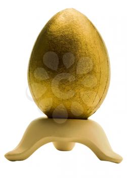 Royalty Free Photo of a Golden Egg on a Stand