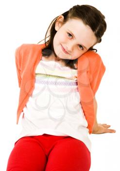 Royalty Free Photo of a Young Girl Sitting on the Floor Smiling